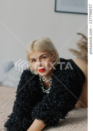 Beautiful woman posing for photographer on bed in Beautiful woman posing for photographer on bed in 137706657