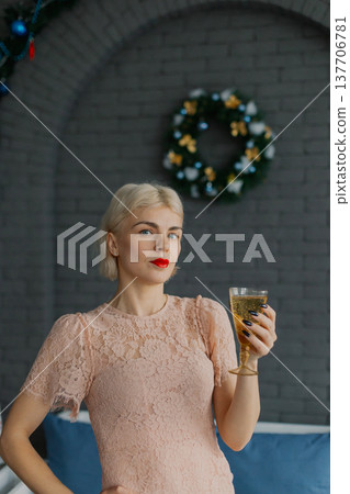 Woman with a glass of champagne in her hands 137706781