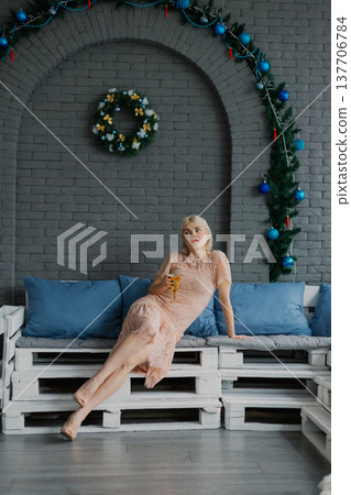 Woman posing for camera in photo studio on wooden Woman posing for camera in photo studio on wooden 137706784