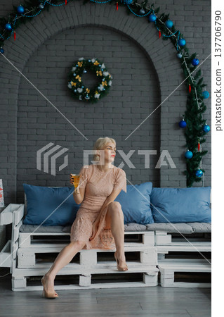 Woman posing for camera in photo studio on wooden Woman posing for camera in photo studio on wooden 137706790