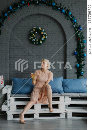 Woman posing for camera in photo studio on wooden Woman posing for camera in photo studio on wooden 137706792