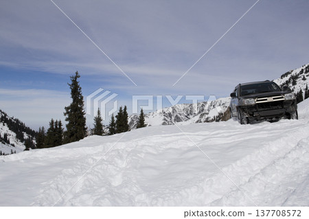 Off-Road SUV Buried in Deep Mountain Snow During Winter Expedition 137708572