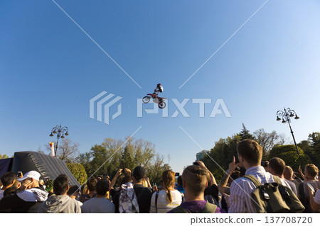 A crowd of spectators watching an extreme motorcycle jump show in Almaty 137708720