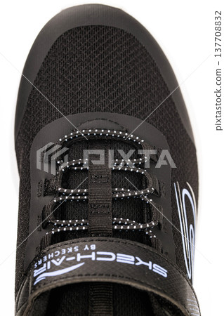 Detail of black running shoe with mesh material and reinforced lacing 137708832