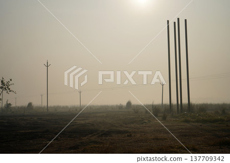 Industrial Construction Site and Utility Poles in Dense Morning Mist Industrial Construction Site and Utility Poles in Dense Morning Mist 137709342