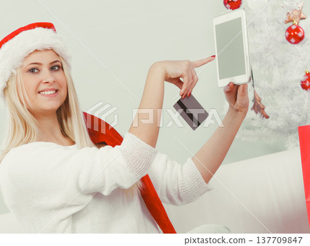 Girl with tablet credit card doing online shopping 137709847