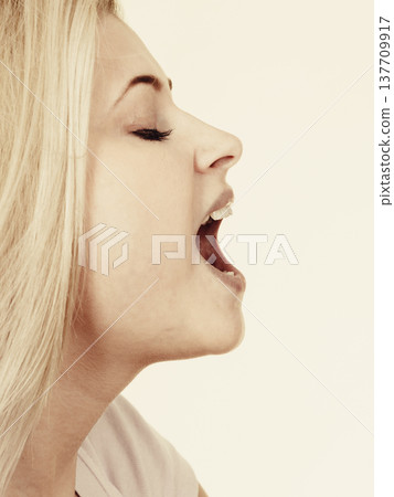 Portrait of woman about to take bite 137709917