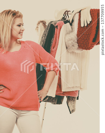 Woman in home closet choosing clothing 137709955