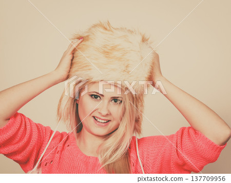Attractive woman wearing furry winter hat Attractive woman wearing furry winter hat 137709956