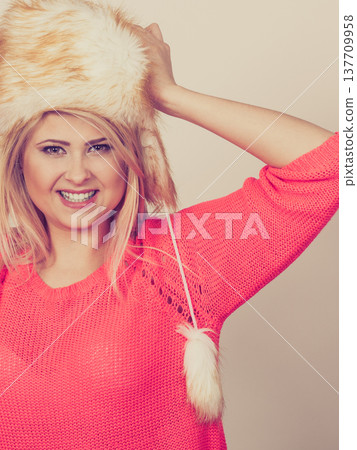 Woman wearing winter furry warm hat 137709958