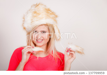 Attractive woman wearing furry winter hat Attractive woman wearing furry winter hat 137709959
