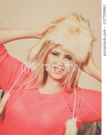 Attractive woman wearing furry winter hat Attractive woman wearing furry winter hat 137709961