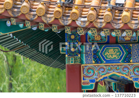 Ornate chinese temple roof eaves and colorful painted details Ornate chinese temple roof eaves and colorful painted details 137710223