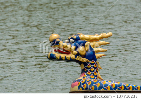 Colorful dragon boat head on water background Colorful dragon boat head on water background 137710235