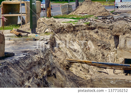 Pit hole with cables and water sewer pipes for repair,replacement 137710252