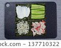 Fluffy white rice added to final quarter of nori sheet. Complete assembly of four toppings for lazy sushi sandwich. Last step before folding into perfect homemade Japanese snack 137710322