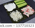 Nori sheet fully loaded with cream cheese, cucumber, crab, and rice. Perfect make-ahead filling for portable Japanese-style sandwich. Ideal for bento boxes, picnics, and healthy office lunches 137710323