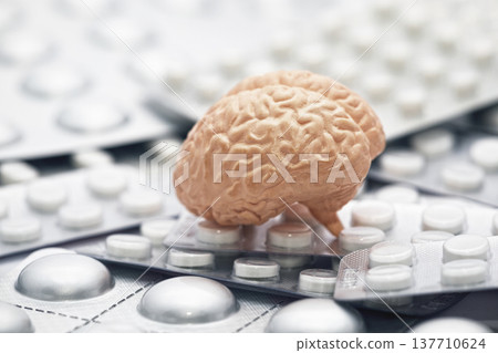 Human brain on heap of many various pills and tablets packs Human brain on heap of many various pills and tablets packs 137710624