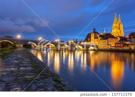 Stone Bridge and cathedral at night in Regensburg on Danube River Germany Stone Bridge and cathedral at night in Regensburg on Danube River Germany 137711379