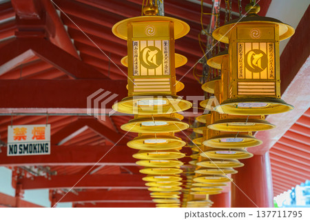 Osaka, Japan - Sep 21 2024, close up view of golden ritual lanterns under roof of a gallery of the Shitenno-ji Buddhist temple, at daytime, Osaka, Japan 137711795