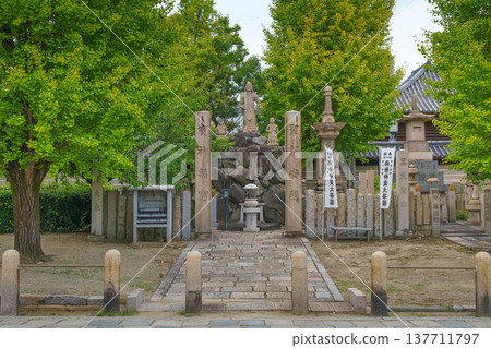 Osaka, Japan - Sep 21 2024, panoramic view of the building in cemetery an grounds of Shitennoji temple, with trees on a background and cloudy sky, without people, Osaka, Japan 137711797