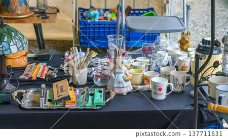 Osaka, Japan - Sep 21 2024, Close-up view of a counter with various antique toys and household items related to Japanese culture at flea market on territory of the Shitenno-ji Temple Osaka, Japan  137711831
