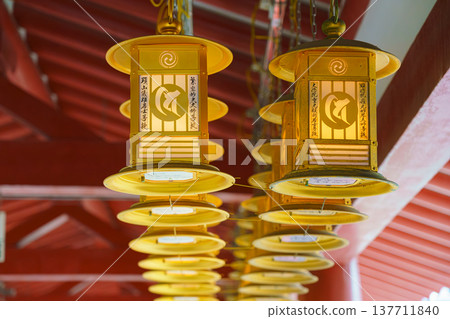 Osaka, Japan - Sep 21 2024, close up view of golden ritual lanterns under roof of a gallery of the Shitenno-ji Buddhist temple, at daytime, Osaka, Japan Osaka, Japan - Sep 21 2024, close up view of golden ritual lanterns under roof of a gallery of the Shitenno-ji Buddhist temple, at daytime, Osaka, Japan 137711840