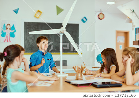 Children presenting a wind turbine model in a classroom science project about renewable energy and sustainability Children presenting a wind turbine model in a classroom science project about renewable energy and sustainability 137712160