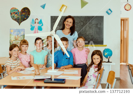 Teacher and elementary students in classroom with wind turbine project learning about renewable energy 137712193