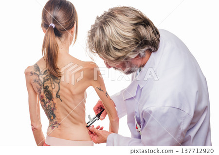 Doctor performing body composition analysis on a woman 137712920