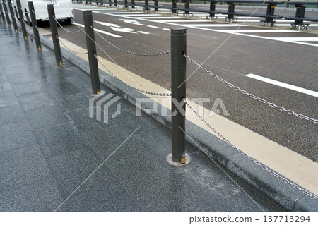 Osaka, Japan - Sep 22 2024, close-up view of quick-release road barriers, metal fence chained to the ground with small locks, during daytime, without people, Osaka, Japan 137713294
