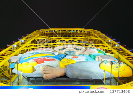 Osaka, Japan - Sep 22 2024, panoramic view from below of Don Quijote Dotonbori shopping and entertainment complex and Ferris wheel, in Dotonbori district, on canal corniche, at nighttime, Osaka, Japan 137713408
