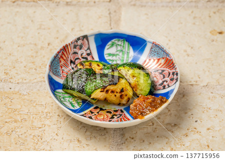 Grilled zucchini over charcoal: A fragrant grilled vegetable dish. Grilled zucchini over charcoal: A fragrant grilled vegetable dish. 137715956