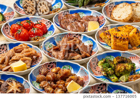 A platter of charcoal-grilled dishes; a collection of izakaya-style grilled menu items. A platter of charcoal-grilled dishes; a collection of izakaya-style grilled menu items. 137716005