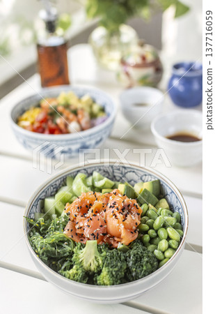smoked salmon and green vegetable healthy poke bowl on white table in melbourne australia cafe smoked salmon and green vegetable healthy poke bowl on white table in melbourne australia cafe 137716059