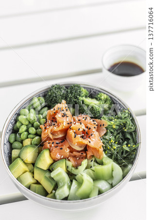 smoked salmon and green vegetable healthy poke bowl on white table in melbourne australia cafe 137716064