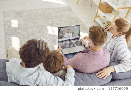 Family listening recommendations having online video call with a doctor at home. 137716069