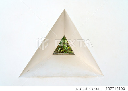 Himeji, Japan - Sep 24 2024, a close-up view of loophole in a form of triangle through which foliage of trees is visible, fortress wall of Himeji Castle, White Heron Castle, at daytime, Himeji, Japan 137716100
