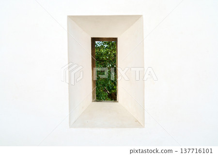 Himeji, Japan - Sep 24 2024, a close-up view of loophole in a form of rectangle through which foliage of trees is visible, fortress wall of Himeji Castle, White Heron Castle, at daytime, Himeji, Japan Himeji, Japan - Sep 24 2024, a close-up view of loophole in a form of rectangle through which foliage of trees is visible, fortress wall of Himeji Castle, White Heron Castle, at daytime, Himeji, Japan 137716101