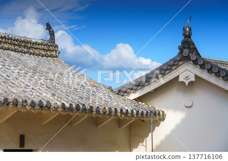 Himeji, Japan - Sep 24 2024, panoramic view of roofs decorated with tiles and sculptures sculptures of Shachihoko, a creature from Japanese folklore, White Heron Castle, with a blue sky, Himeji, Japan Himeji, Japan - Sep 24 2024, panoramic view of roofs decorated with tiles and sculptures sculptures of Shachihoko, a creature from Japanese folklore, White Heron Castle, with a blue sky, Himeji, Japan 137716106