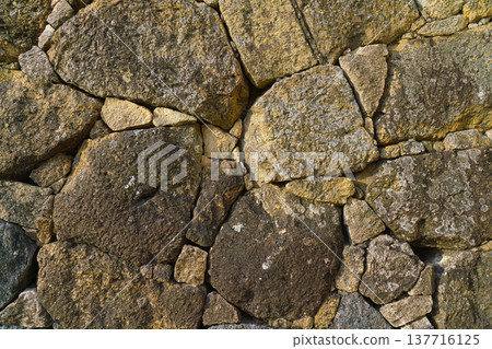 Himeji, Japan - Sep 24 2024, Close-up view of the cobblestone fortress wall, consisting of large stones, without people, in the daytime, Himeji, Japan 137716125