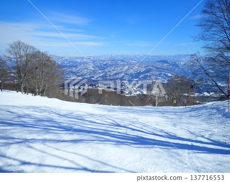 A wintery ski slope covered in a blanket of white snow. A wintery ski slope covered in a blanket of white snow. 137716553