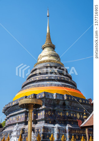 Vertical view of Wat Phra That Lampang Luang an iconic Buddhist temple was founded in the 13th century, One of the best examples of Lanna architecture in Lampang province of Thailand. 137716905