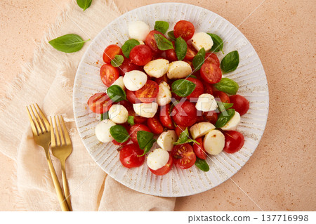 Caprese salad with cherry tomatoes , mozzarella cheese, basil  137716998