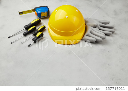 Happy labor day concept. Construction tools, yellow helmet on dark wooden background Happy labor day concept. Construction tools, yellow helmet on dark wooden background 137717011