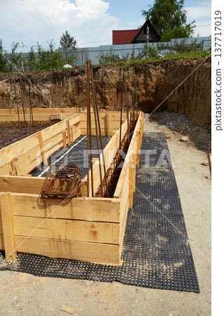 The construction of a concrete foundation using reinforcing steel prepared at the construction site. The construction of a concrete foundation using reinforcing steel prepared at the construction site. 137717019
