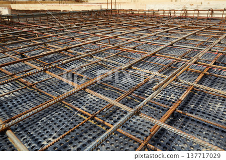 The construction of a concrete foundation using reinforcing steel prepared at the construction site The construction of a concrete foundation using reinforcing steel prepared at the construction site 137717029
