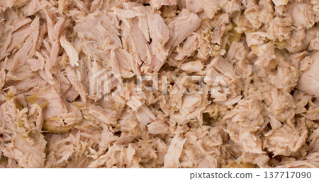 Shredded chicken on a surface with a plain background during meal preparation in a kitchen 137717090