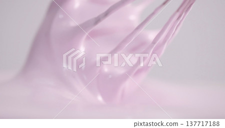 Mixing pink icing for cake decoration in a kitchen during the day 137717188