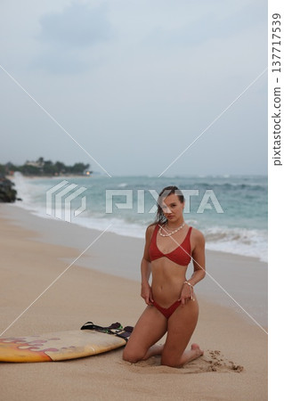 Surf Instructor Posing Confidently Outdoors. Portrait Of Surfer On Sandy Shoreline Enjoying Sunshine 137717539